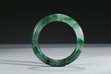 A JADEITE CARVED BANGLE