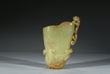 A CARVED YELLOW JADE 'DRAGON' LIBATION CUP