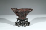 AN AGARWOOD CARVED LIBATION CUP WITH STAND