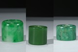 A GROUP OF THREE CARVED JADE ARCHER'S RINGS