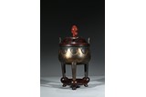 A GILT-BRONZE TRIPOD CENSER AND COVER