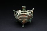 A BRONZE TRIPOD VESSEL AND COVER