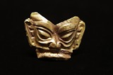 A RARE GOLD FIGURE MASK