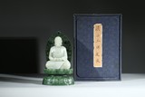 A WHITE JADE FIGURE OF BUDDHA