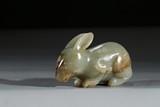 A CARVED CELADON JADE RABBIT