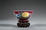 AN IMPERIAL FAMILLE VERTE RED GROUND 'FLORAL' BOWL 
