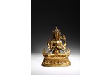 A GILT BRONZE FIGURE OF FOUR-ARMED BODHISATTVA