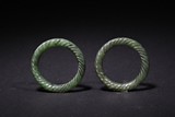 A PAIR OF SMALL GREEN JADE BANGLES