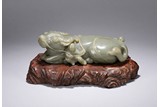 A CELADON JADE CARVING OF BUFFALO AND BOYS