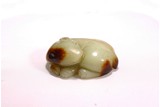 A YELLOW AND RUSSET JADE CARVING OF MYTHICAL BEAST