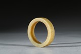 A YELLOW JADE CARVED 'INSCRIBED' RING 
