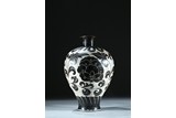 A BRONZE WHITE GROUND BLACK FOLIATE SCROLL DECORATED VASE