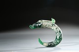 A CALCIFIED GREEN GLASS FISH PENDANT