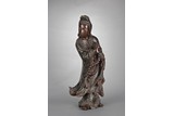 A ROSEWOOD CARVED STANDING GUANYIN FIGURE
