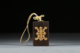 AN AGARWOOD GOLD INLAID PENDANT