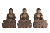 A SET OF THREE LARGE WOODEN STATUES OF SEATED BUDDHA