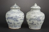 A PAIR OF BLUE AND WHITE 'CRANES' SMALL JARS WITH COVERS