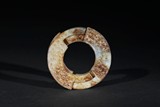 A WHITE AND RUSSET JADE RING CARVING