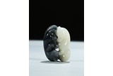 A WHITE AND BLACK JADE CARVING OF TWO CATS