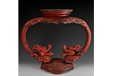 A CINNABAR LACQUER WOOD CARVED DRAGONS STAND