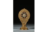 A GILT PAINTED DHARMACHAKRA 
