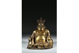 A GILT BRONZE FIGURE OF SEATED BUDAI