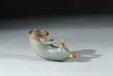 A CELADON JADE CARVED GILT 'RAM' HEAD CUP 