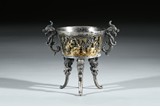 A SILVER GILT CAST 'CHICKEN' TRIPOD CUP