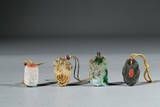 A GROUP OF FOUR HARDSTONE AND JADE 'ZHAIJIE' PENDANTS