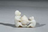 A WHITE JADE 'MONKEY AND PEACH' CARVING