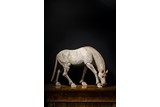 A PAINTED POTTERY FIGURE OF A HORSE 