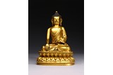 A GILT BRONZE FIGURE OF SEATED SHAKYAMUNI 