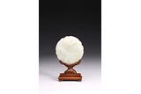 A SMALL WHITE JADE CIRCULAR PLAQUE WITH STAND