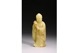 A YELLOW JADE CARVED FIGURE OF LUOHAN