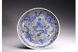 A LARGE UNDERGLAZED BLUE RED 'DRAGON AND WAVES' DISH