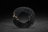 AN OPAQUE BLACK JADE CARVED DISC
