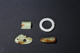 A SET OF FOUR JADE PENDANTS
