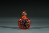 A CHINESE AMBER CARVED SNUFF BOTTLE