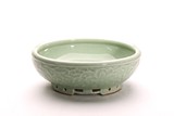 A CHINESE CELADON GLAZED AND MOULDED WASHER