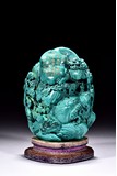 A TURQUOISE CARVED 'DEEP MOUNTAIN' BOULDER