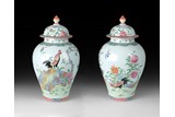 A CHINESE PAIR OF FAMILLE ROSE JARS WITH COVERS