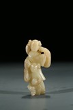A WHITE JADE CARVING OF FIGURES