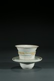 A CHINESE CELADON GLAZE CUP AND HOLDER