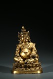 A TIBETAN GILT BRONZE FIGURE OF JAMBHALA