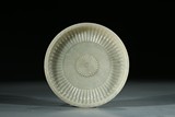 A CHINESE CELADON JADE INSCRIBED CHRYSANTHEMUM DISH