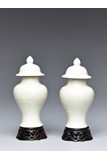 A PAIR OF WHITE GLAZED VASES AND COVER