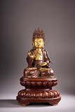 A CHINESE GILT BRONZE FIGURE OF GUANYIN WITH STAND