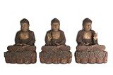 A SET OF THREE LARGE WOODEN STATUES OF SEATED BUDDHA