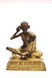 A SINO-TIBETAN GILT BRONZE FIGURE OF MILAREPA