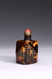 A TORTOISESHELL INSCRIBED FACETED SNUFF BOTTLE